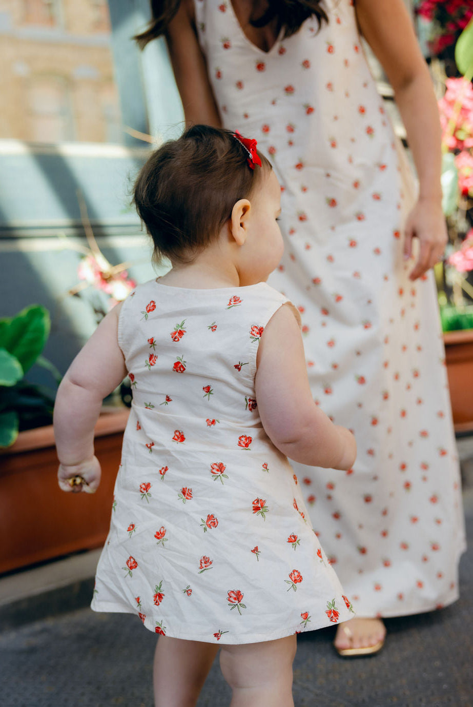 Mom and daughter hugging in matching Red Posey Mommy and Me dresses, Little Gili toddler girls Easter spring dress by Puka The Label