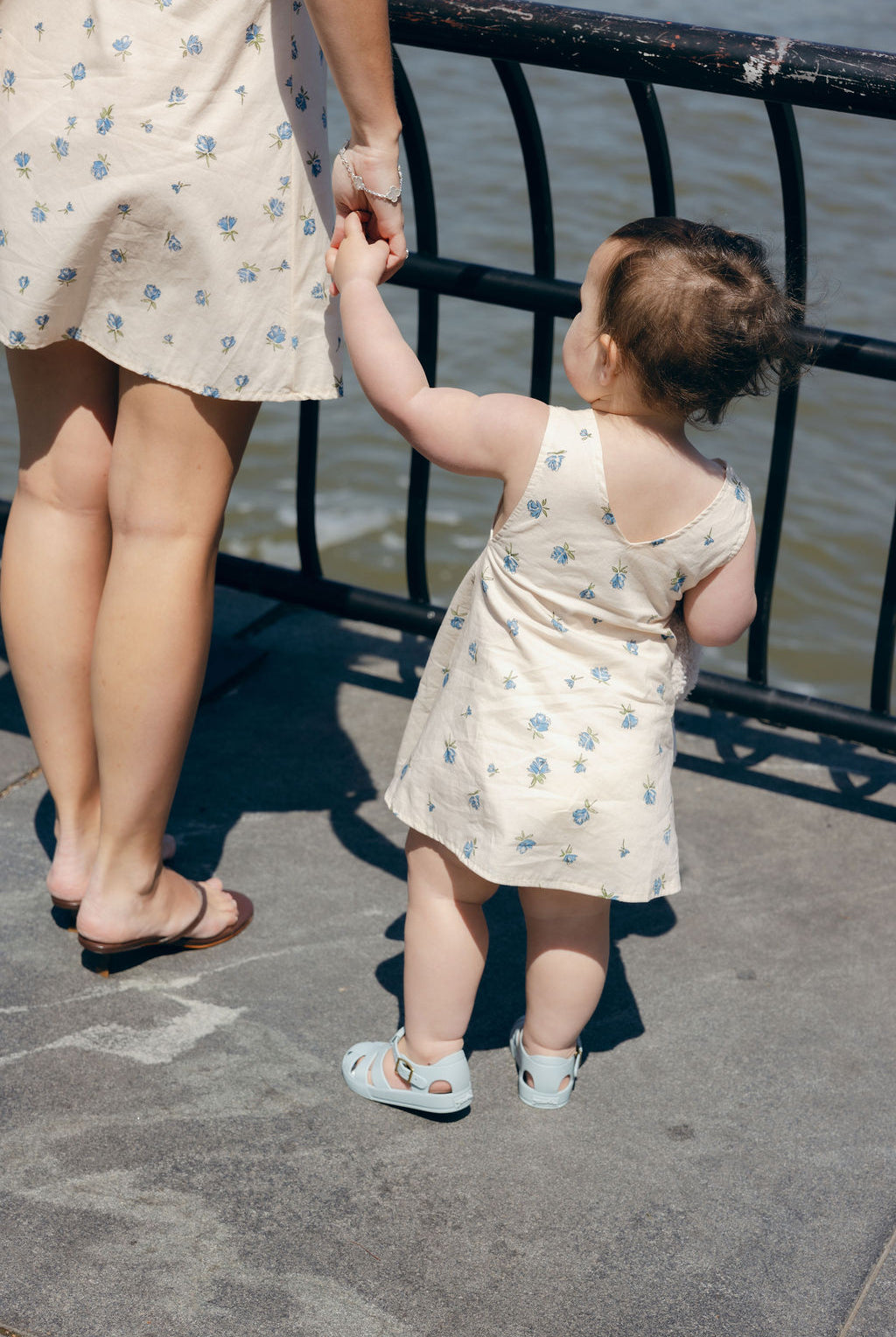 Blue Posey Mini Gili and Little Gili matching Mommy and Me dresses from behind, mother daughter holding hands spring summer 2026 Puka The Label