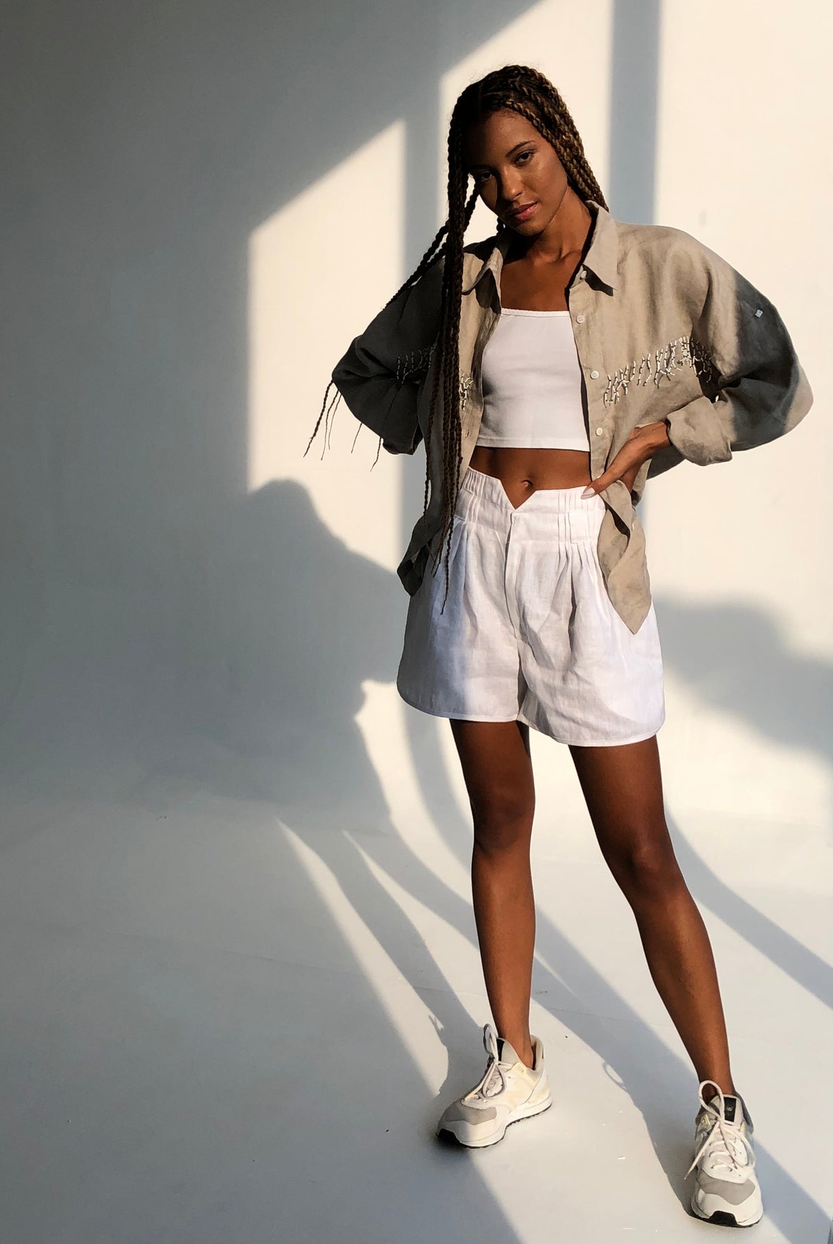 Puka white linen shorts styled as a complete summer outfit — easy women's linen shorts for resort, beach, and weekend wear