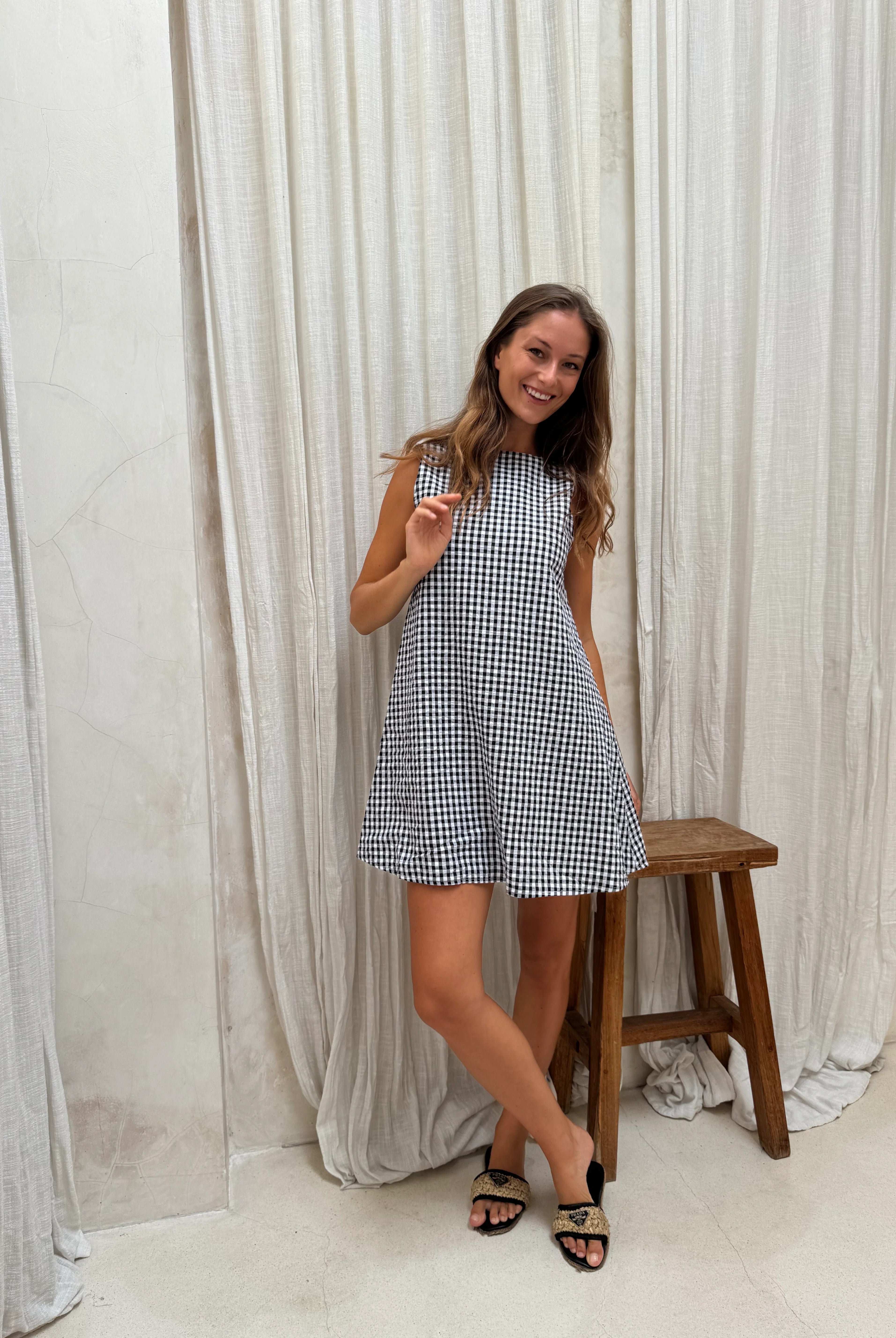Black gingham mini Gili reversible dress on model β V-neck or high neck cotton mini by Puka The Label