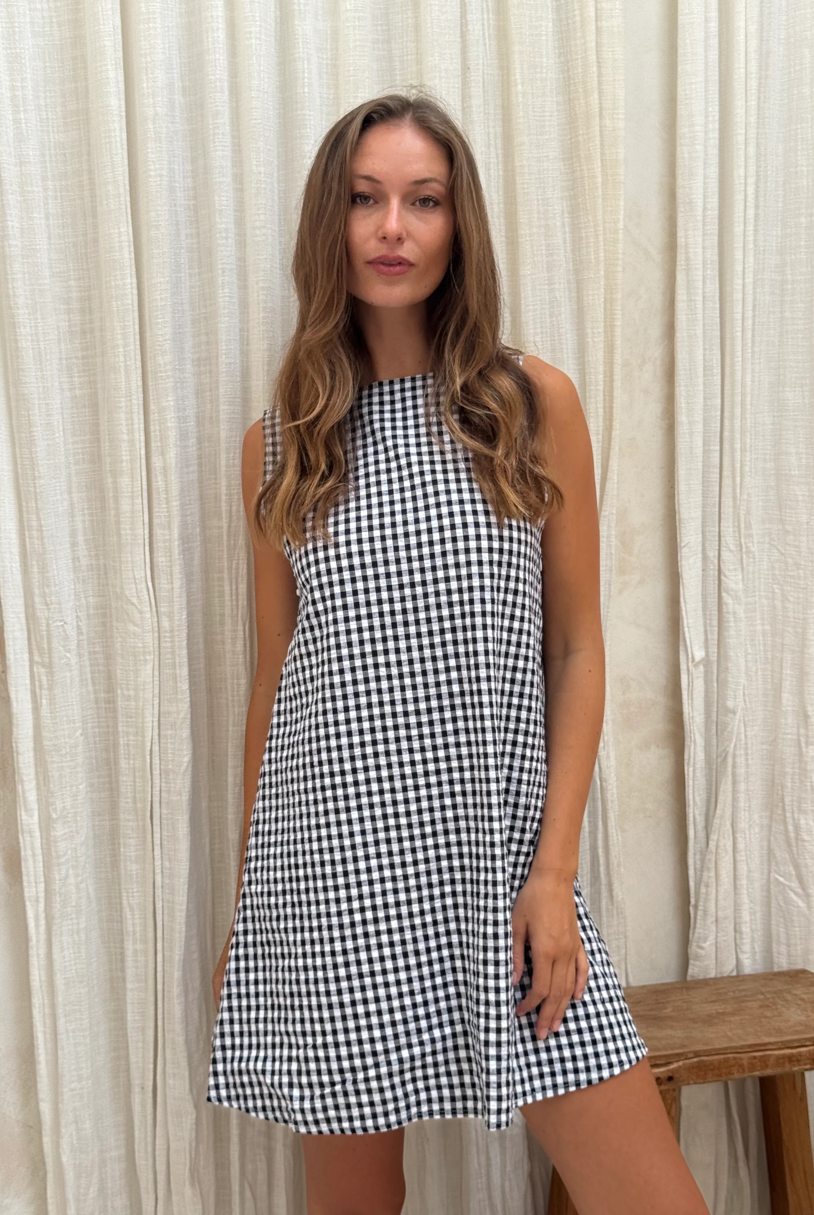 Black gingham mini Gili dress β side profile of the reversible cotton mini silhouette by Puka The Label