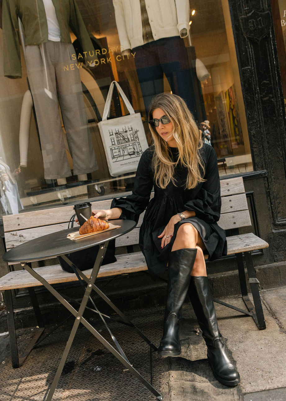 Jules Fox influencer style inspiration, black short mini paired with tall black boots in NYC