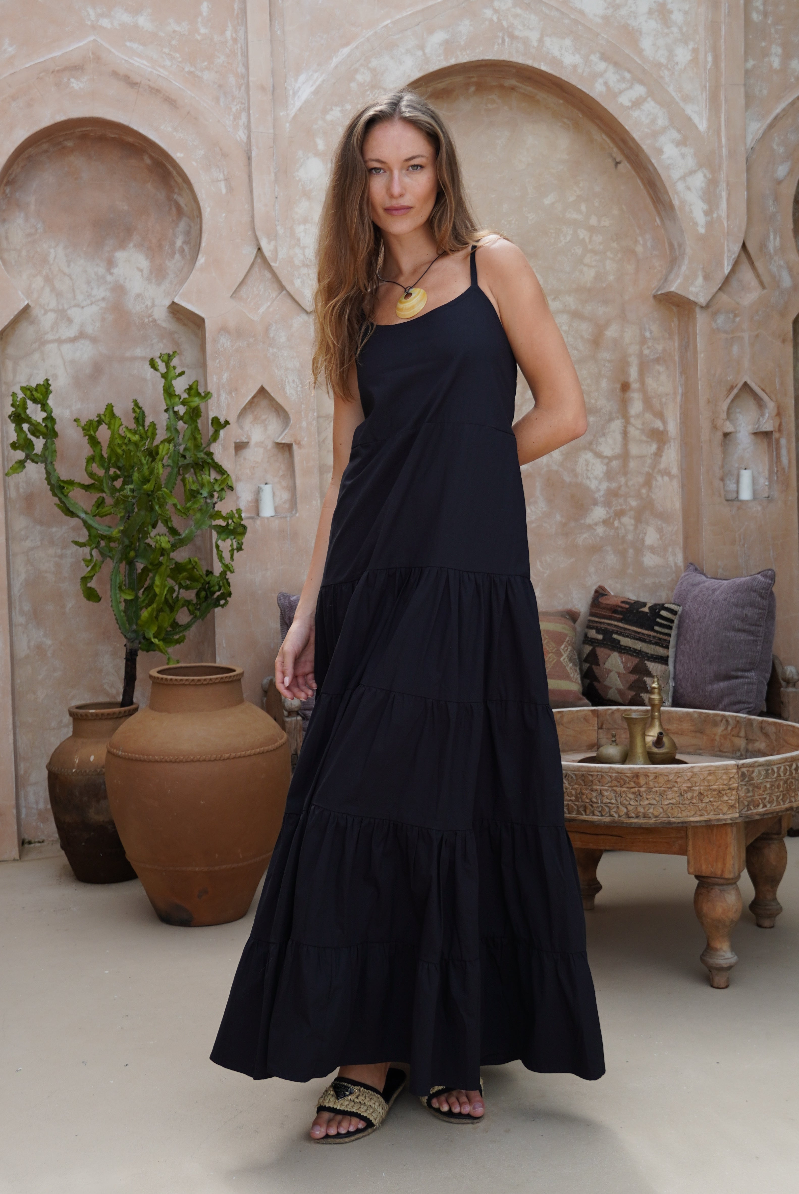 Black tiered cotton maxi dress summer evening outfit 2026, flowy adjustable strap Waverly Dress for date night and rooftop occasion Puka The Label
