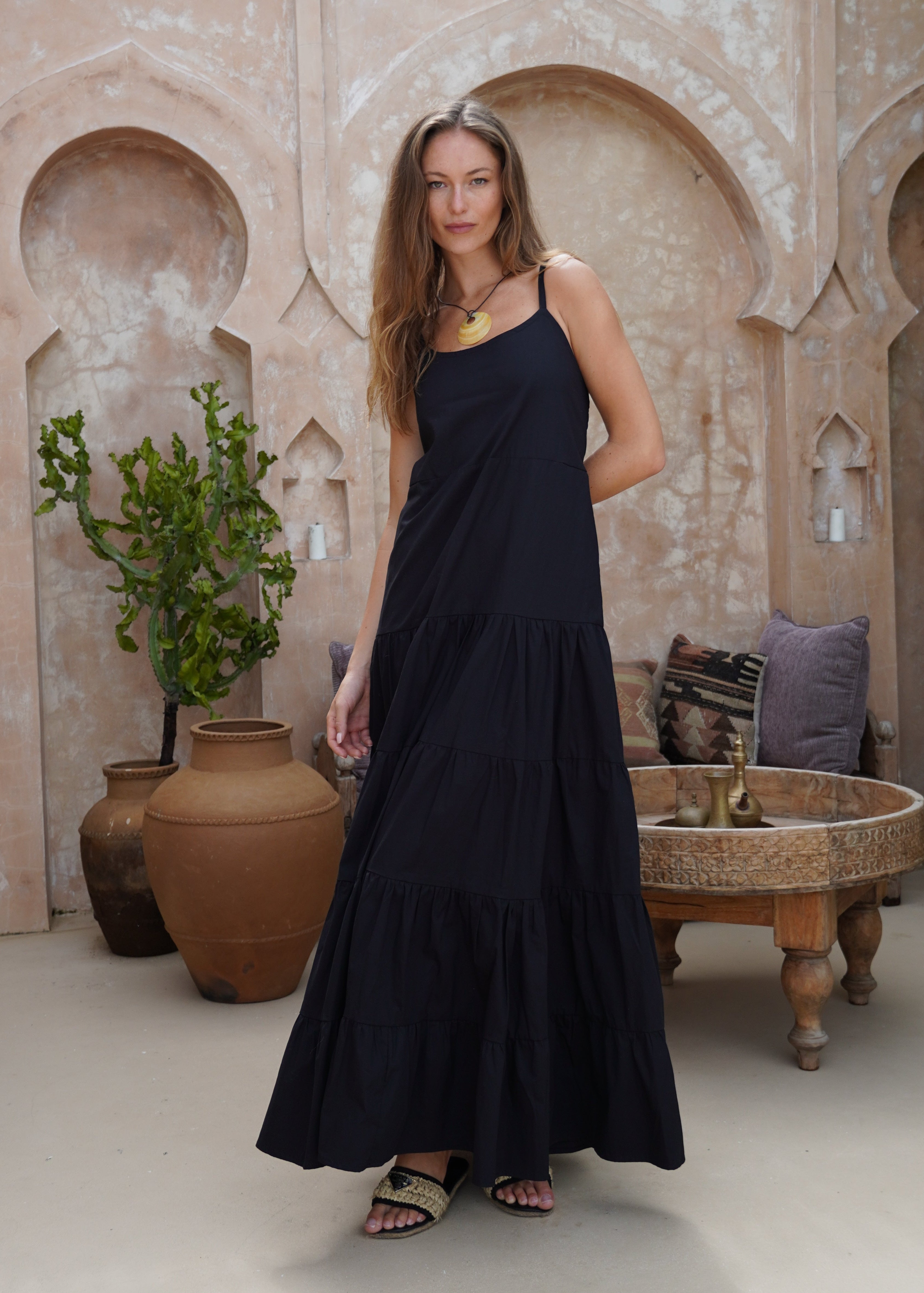 Black tiered cotton maxi dress summer evening outfit 2026, flowy adjustable strap Waverly Dress for date night and rooftop occasion Puka The Label
