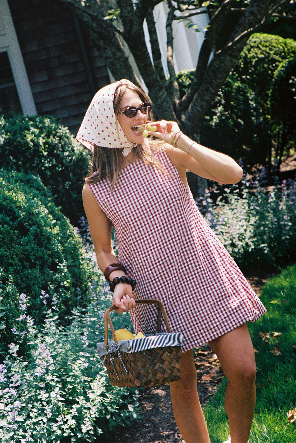 Influencer Hannah Lovey Style wearing red gingham mini dress by Puka The Label styled in the Hamptons, summer outfit, casual beach dress, influencer fashion