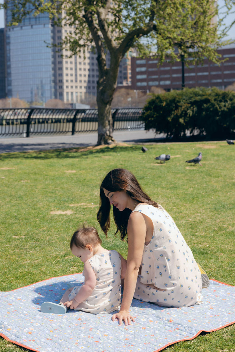 Blue Posey Little Gili girls spring picnic dress, mom and baby in matching blue floral cotton dresses on blanket outdoors Puka The Label
