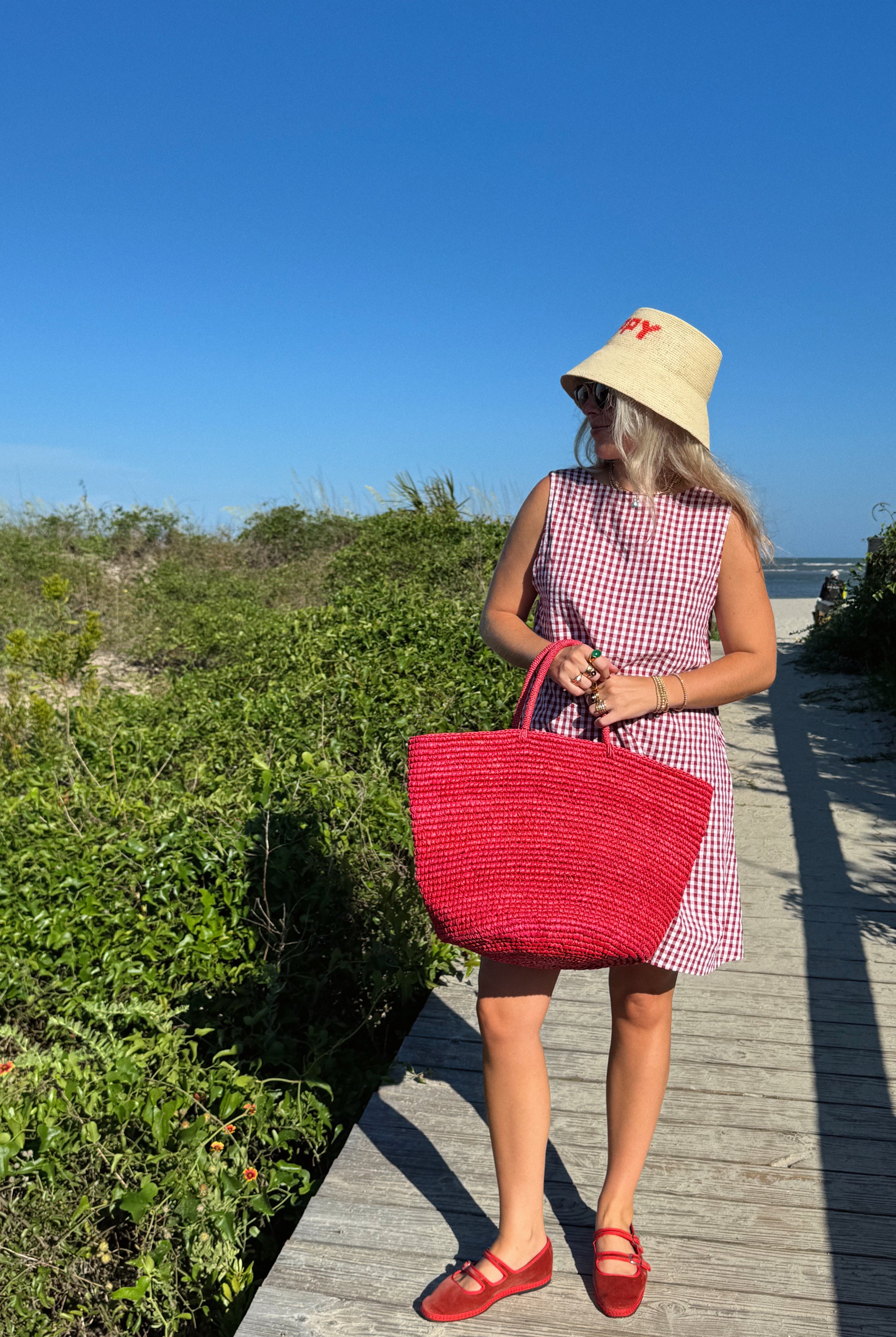 influencer meredith wyche wears a cute short red gingham dress in the summer in SC