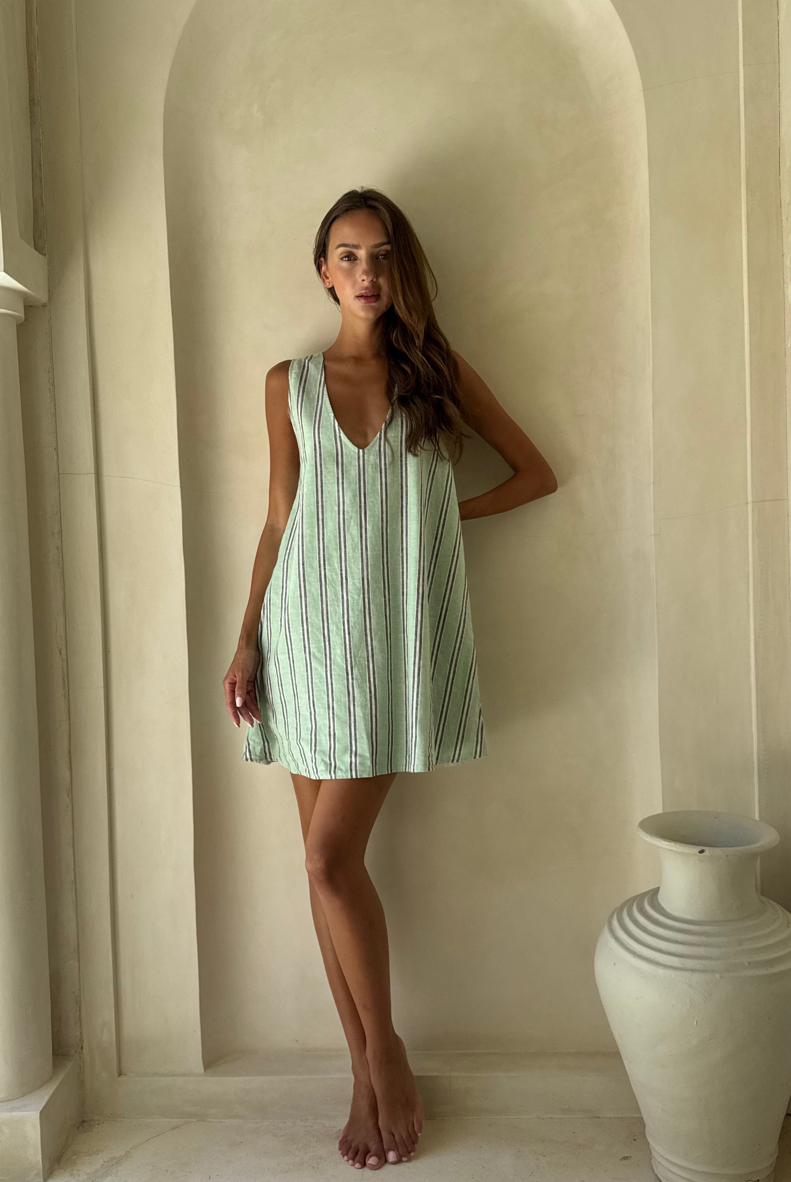 Mini Gili aquamarine green stripe ghost mannequin flat lay, vibrant preppy hemp organic cotton reversible mini dress 55% hemp 45% organic cotton Puka The Label 2026