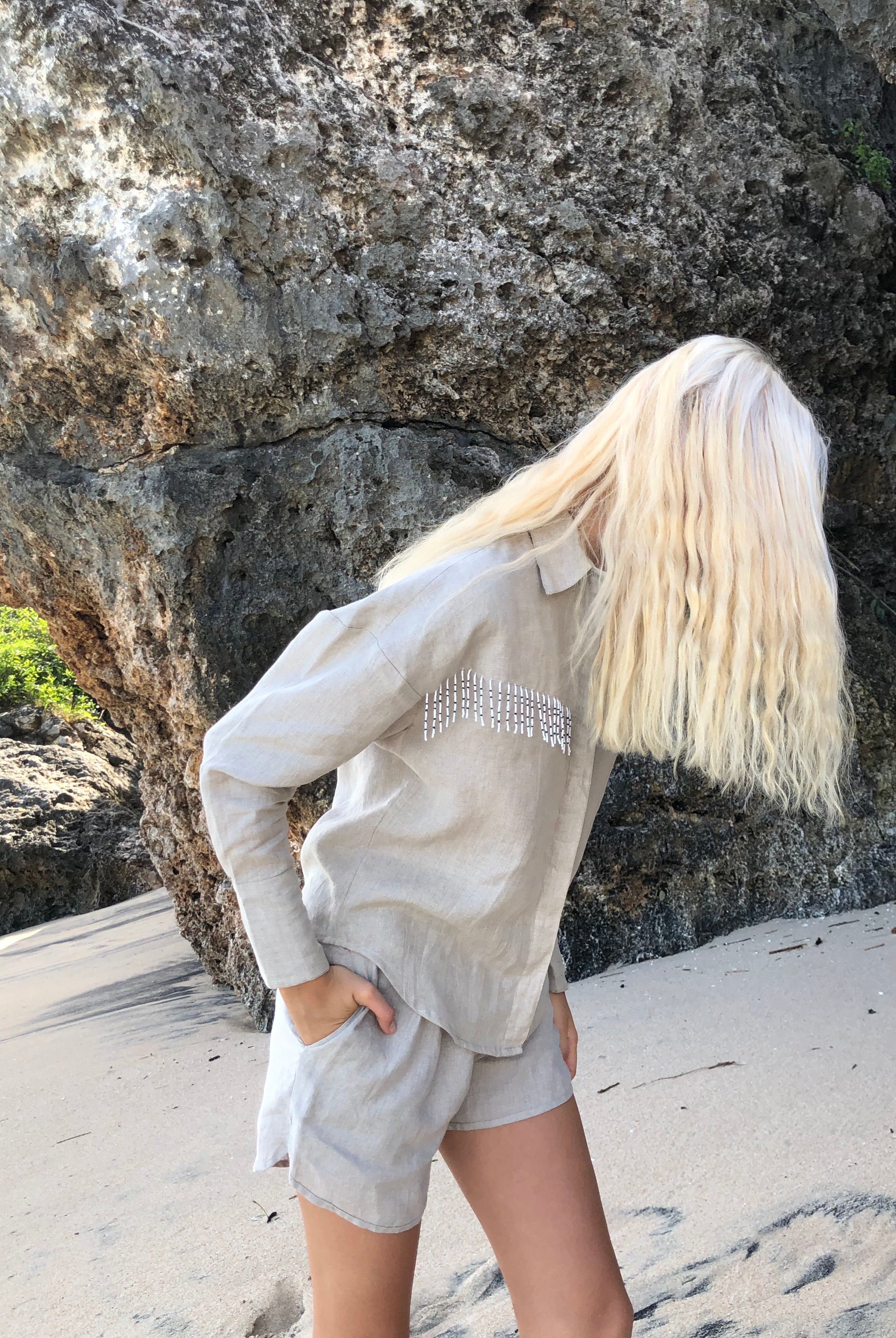 Natural linen Ulu fringe button-up by Puka The Label styled for Aspen fall — elevated western blouse with black and white fringe