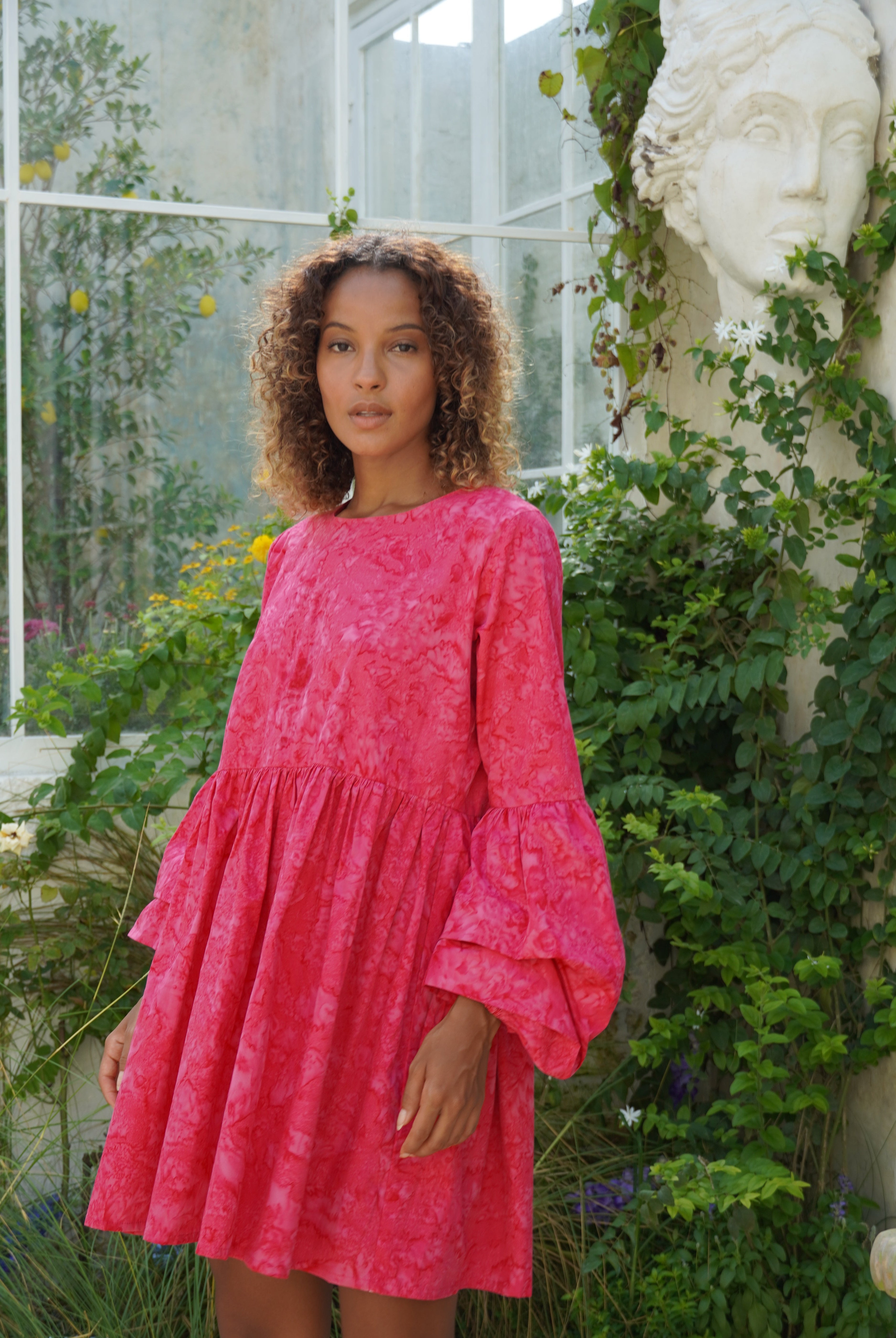 Pink hand-dyed oversized cotton mini dress beach vacation outfit summer 2026, effortless ruffle sleeve dress for warm weather travel and resort getaway