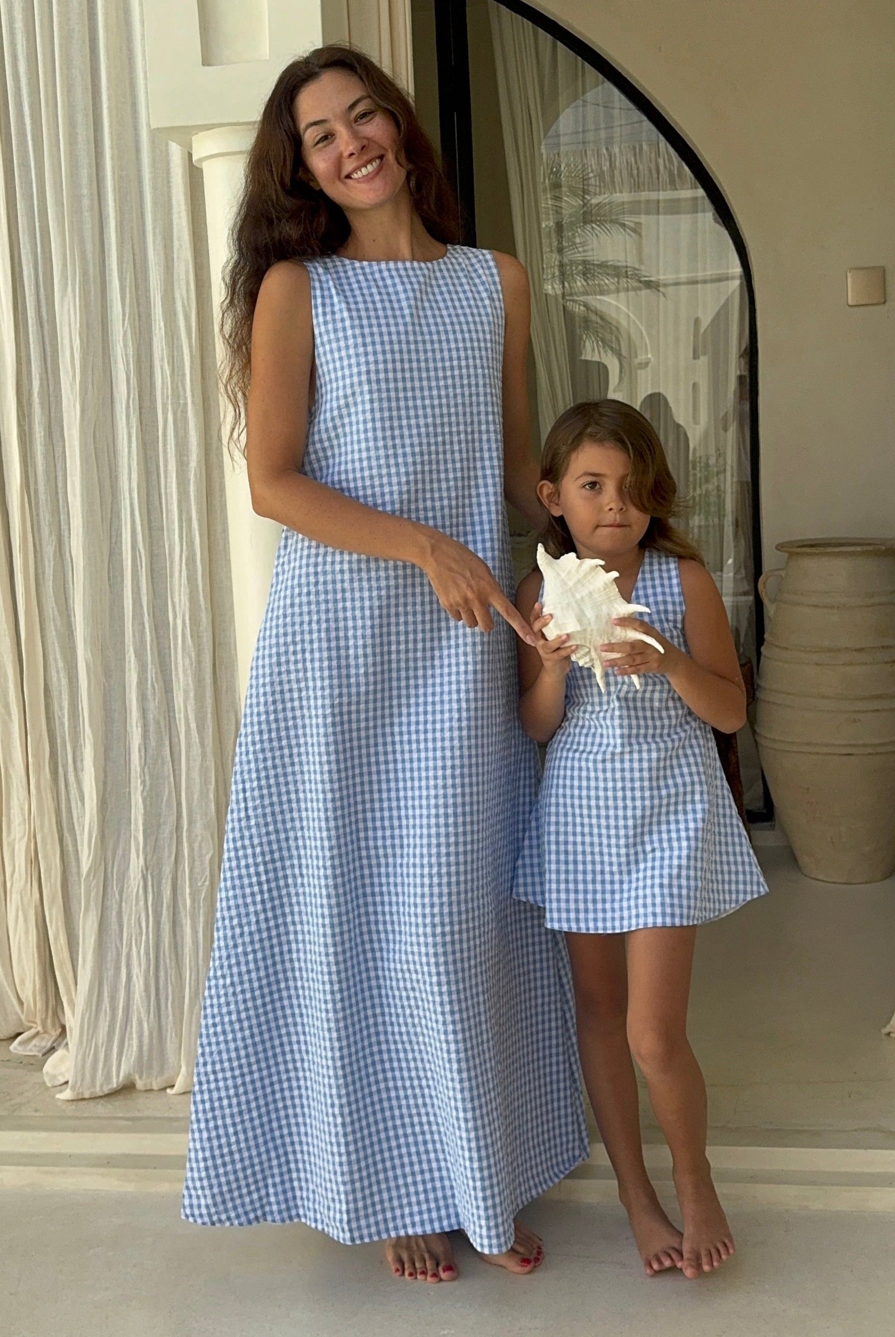 Matching mommy and me light blue gingham dresses on beach vacation, Puka The Label