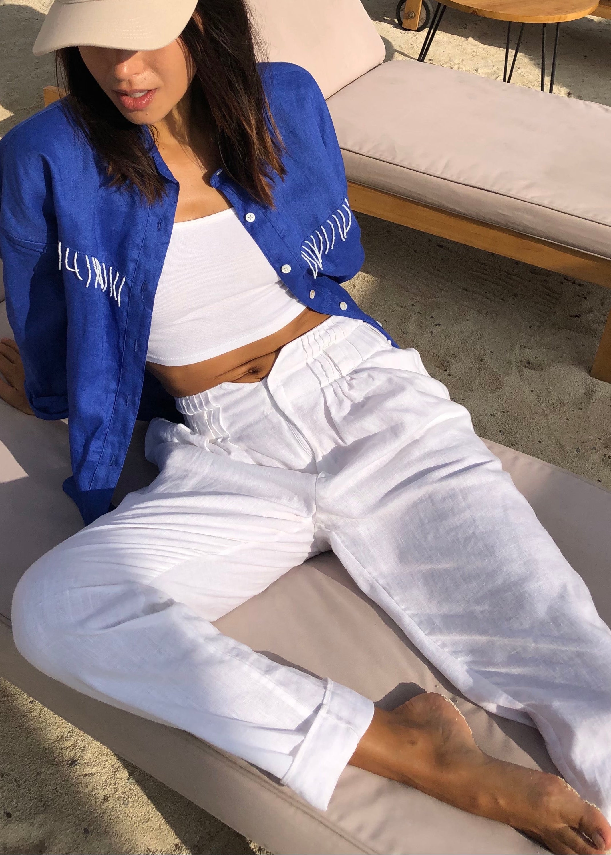 White linen pants styled with an oversized linen top — Puka Pantai Pant, easy women's resort outfit for vacation and coastal weekends