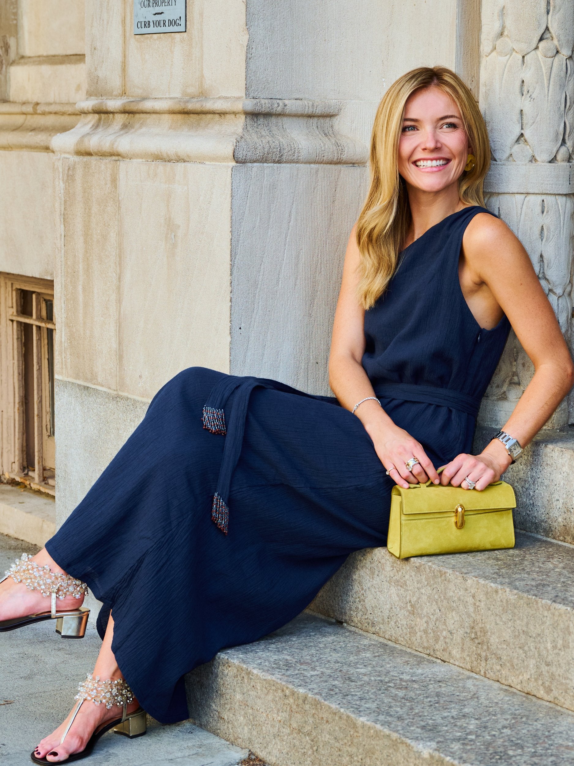 Natalie Simkins in the Camilla Dress Midnight, detail of one-shoulder neckline and self-tie belt