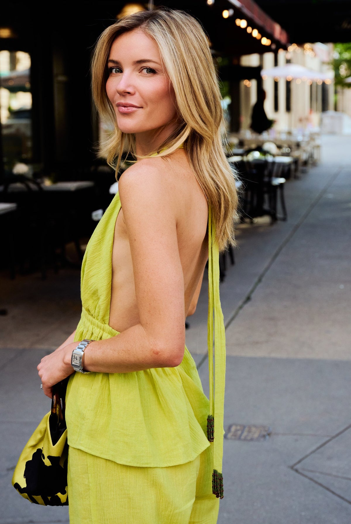 Natalie Simkins wearing the Puka Carlyle Halter Top in Olive Brine — beaded tassel neck tie back detail, New York City pre-fall style