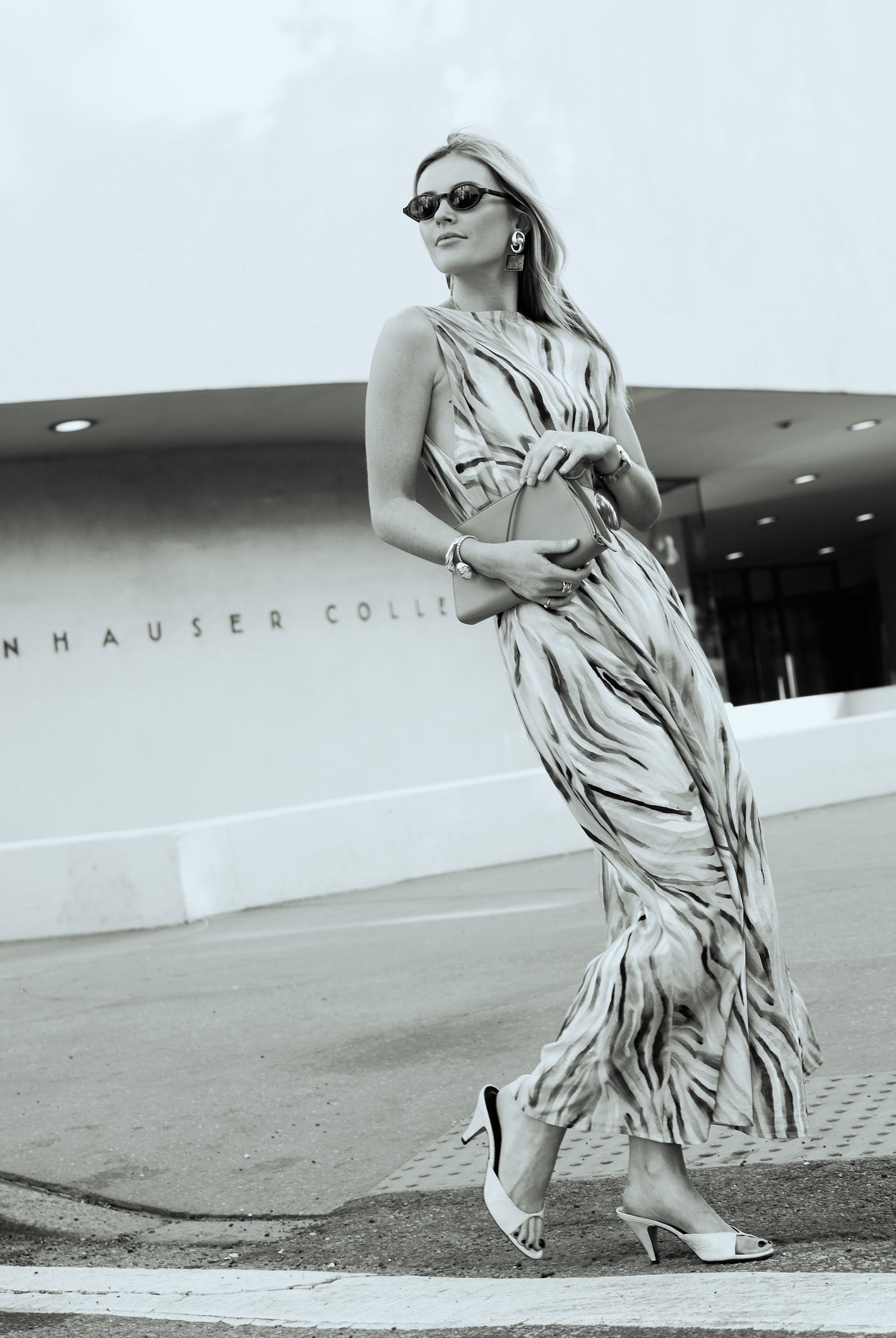 Black and white editorial of Natalie Simkins in the Cleo maxi dress outside the Guggenheim Museum NYC