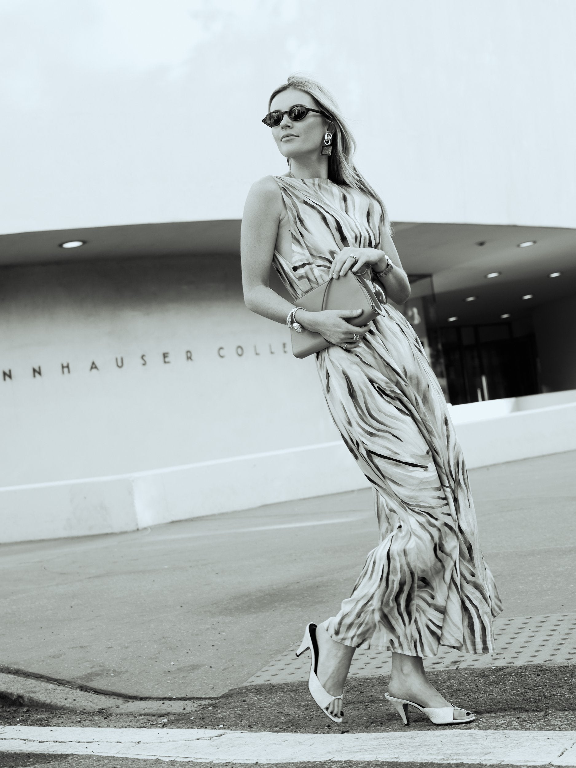 Black and white editorial of Natalie Simkins in the Cleo maxi dress outside the Guggenheim Museum NYC
