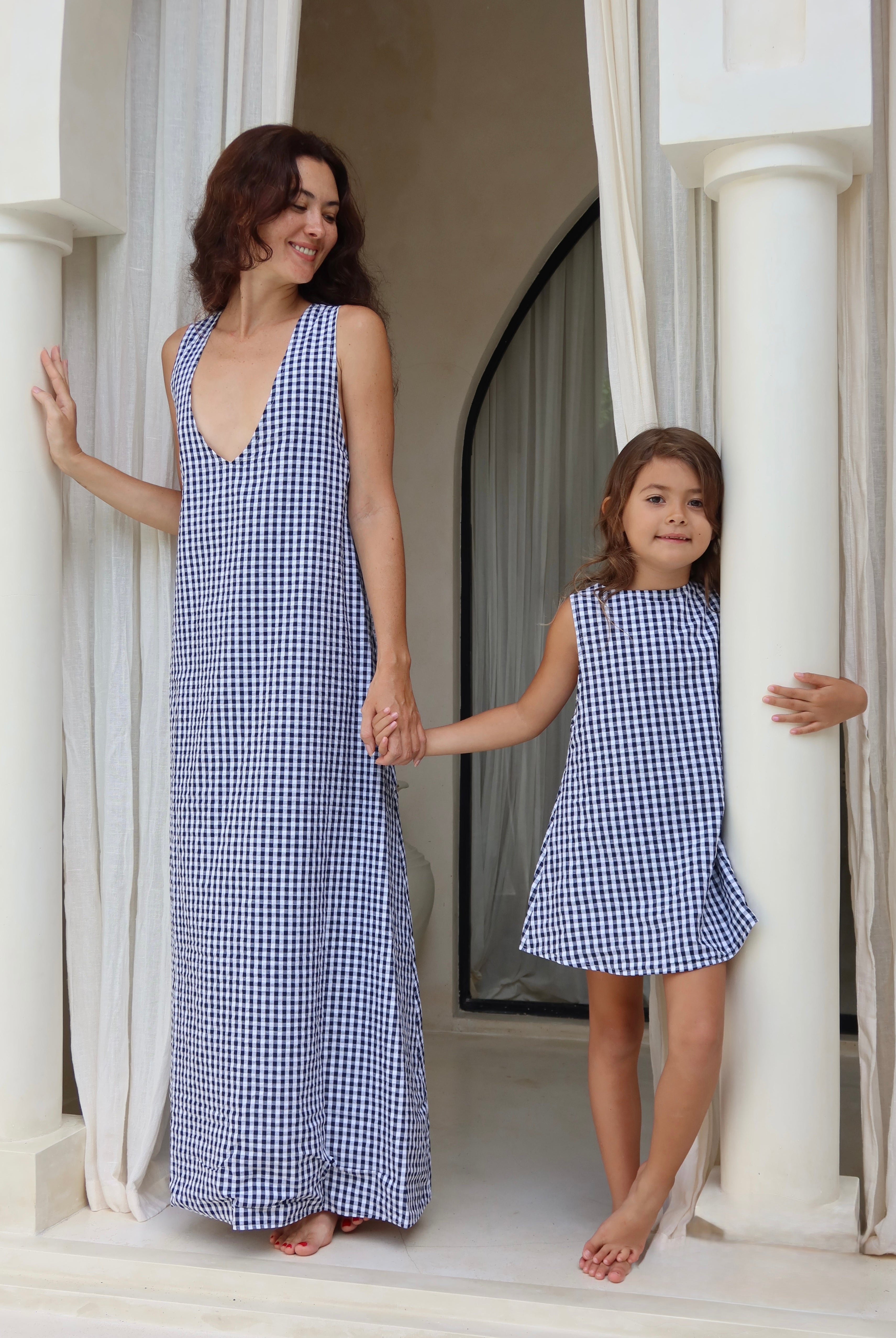 Woman and child in matching blue gingham dresses celebrating Mother's Day