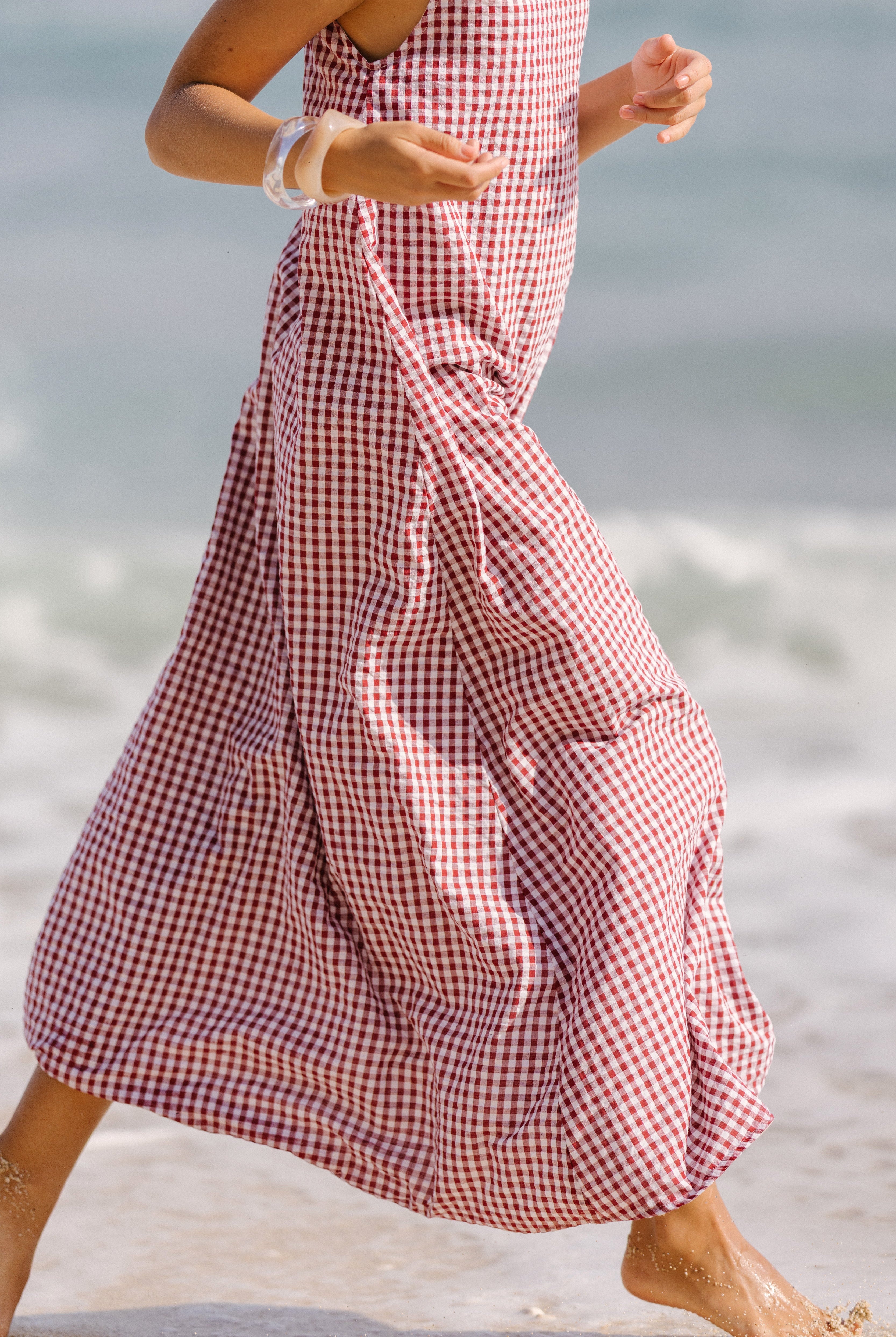 Red gingham Gili maxi dress worn as high neck beach cover-up β bump-friendly lined cotton resort wear, Puka The Label