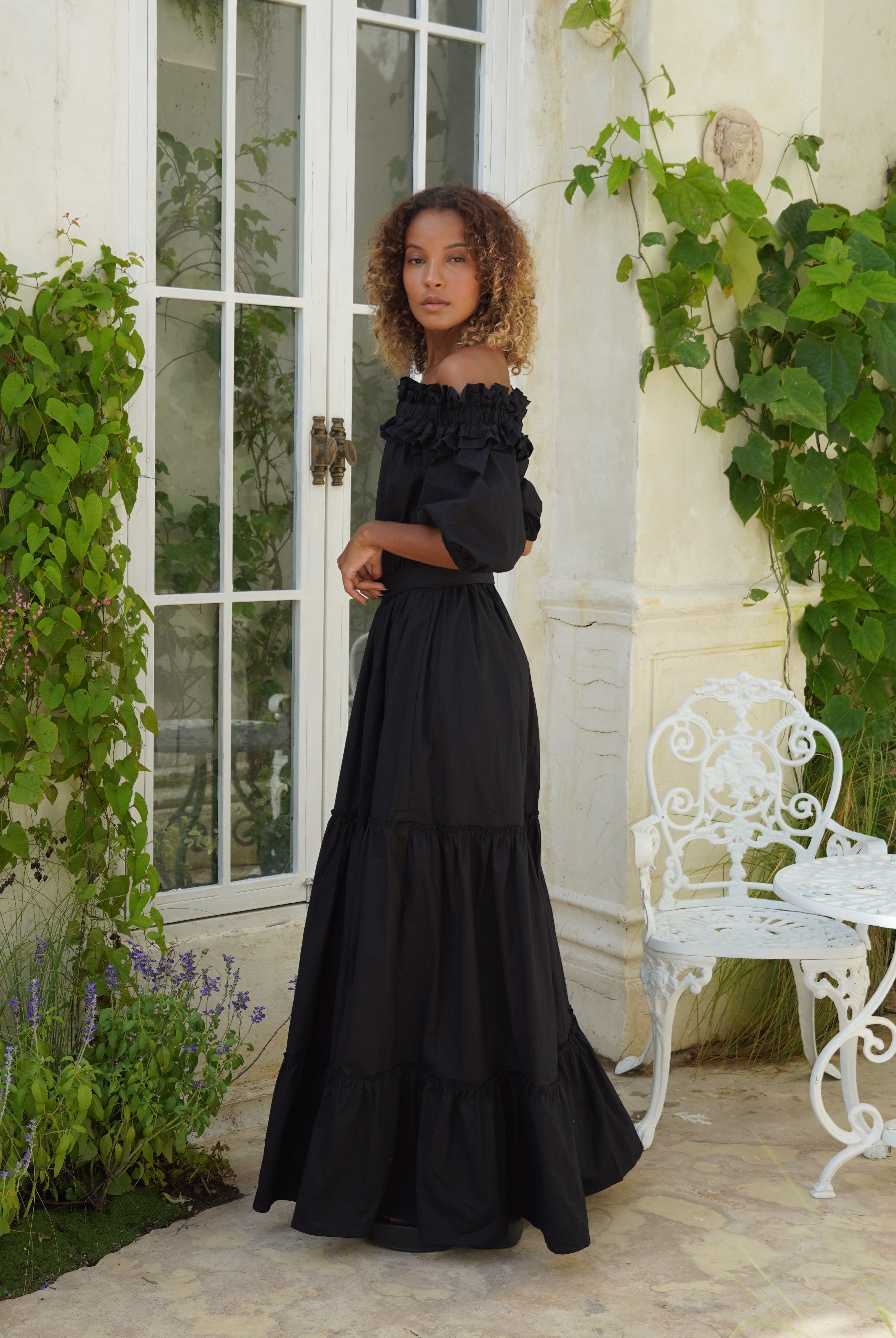 Ruffled off the shoulder black dress coastal evening outfit idea, dramatic flowy maxi dress for beach weddings and parties