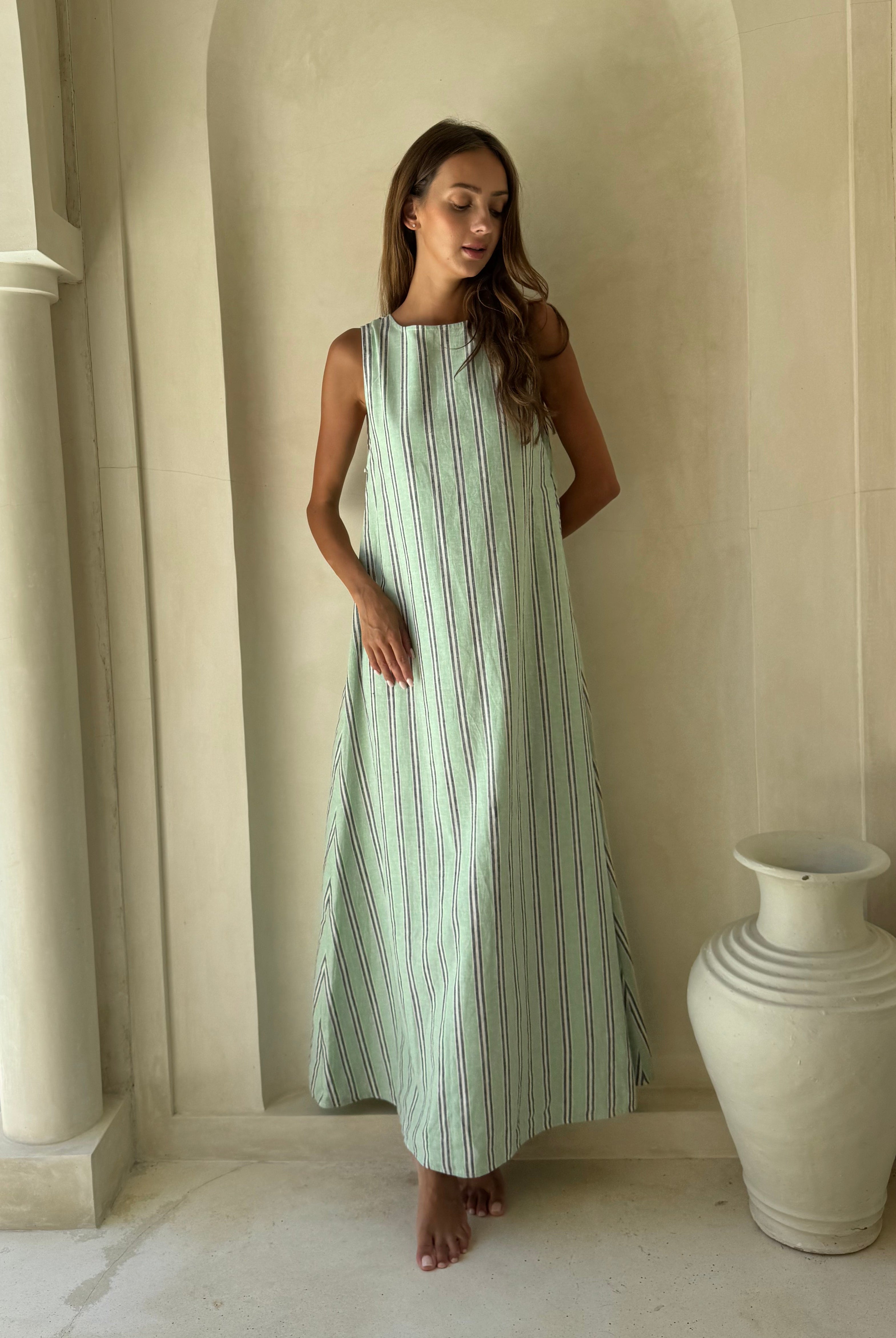 Gili Green Navy and White Stripe Maxi Dress worn in a Santorini-inspired setting, perfect summer travel dress