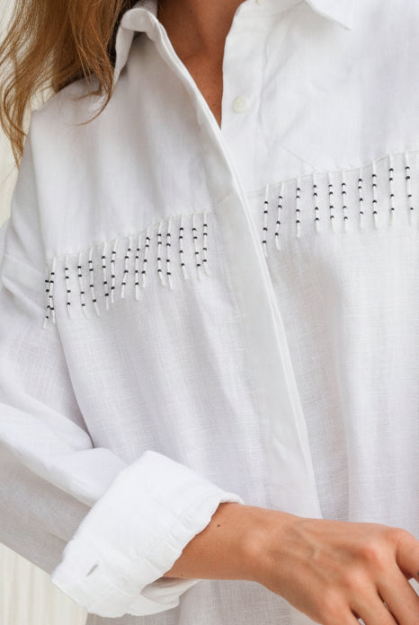 White linen Ulu Dress hand-beaded black and white fringe detail, artisan crafted in Bali studio 100% linen button-up dress Puka The Label
