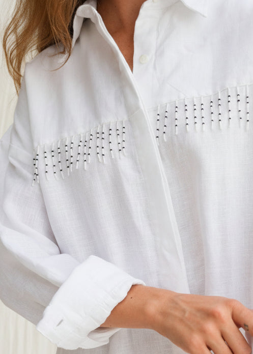 White linen Ulu Dress hand-beaded black and white fringe detail, artisan crafted in Bali studio 100% linen button-up dress Puka The Label