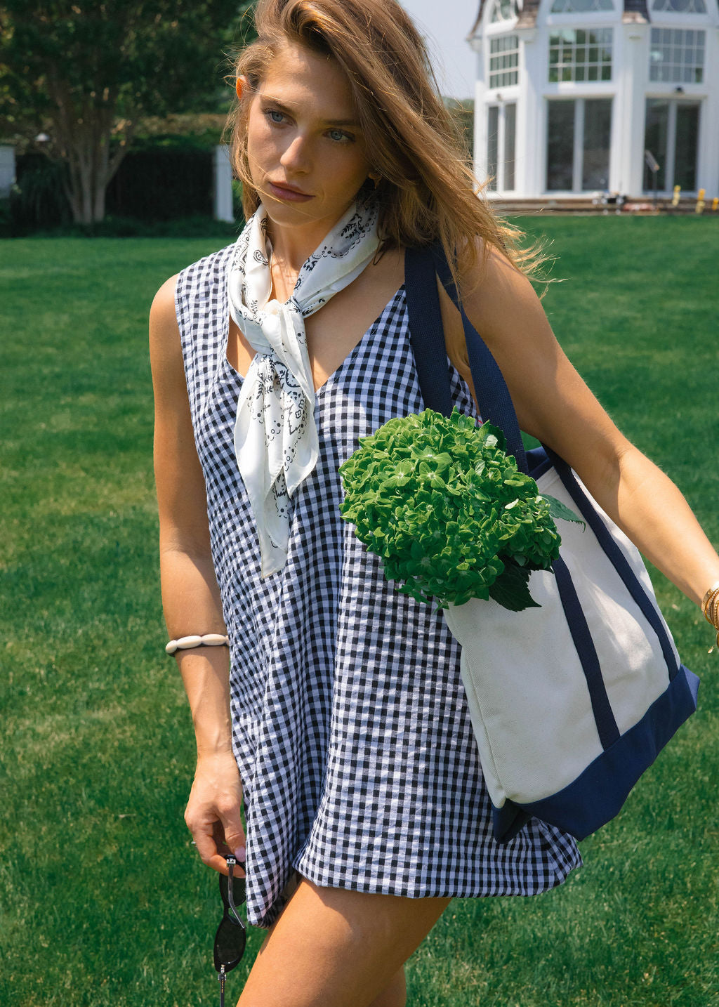 Influencer Hannah Lovey in a short black gingham dress in the summer
