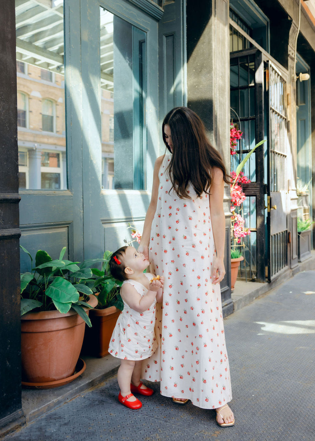 Little Gili Red Posey toddler girls floral dress close up, cream cotton red rose print spring summer Easter kids dress by Puka The Label