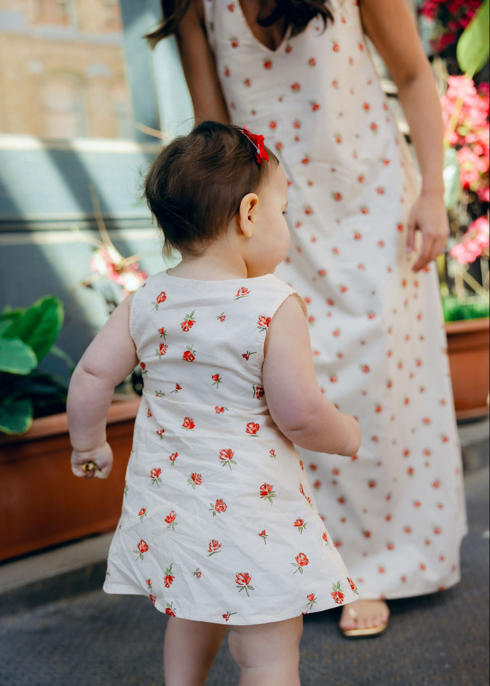 Mom and daughter hugging in matching Red Posey Mommy and Me dresses, Little Gili toddler girls Easter spring dress by Puka The Label