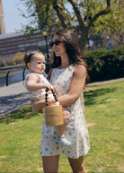 Blue Posey Mini Gili and Little Gili Mommy and Me matching floral dresses, mom holding baby spring summer 2026 Puka The Label