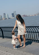 Blue Posey Mini Gili and Little Gili Mommy and Me walk along waterfront, matching blue floral mother daughter spring dresses 2026 Puka The Label