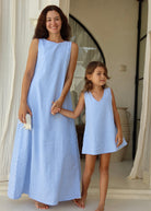 Mommy and me moment in Bali wearing matching summer dresses in light blue gingham.