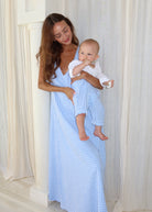 Mom and 1 year old wear matching light blue gingham prints. Long light blue maxi paired with the same color pants. Photoshoot inspiration for new boy moms