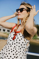 Loren polka dot strapless dress close-up on the water at Montauk Yacht Club — breezy nautical summer dress for Hamptons and MTK weekends, windswept coastal style