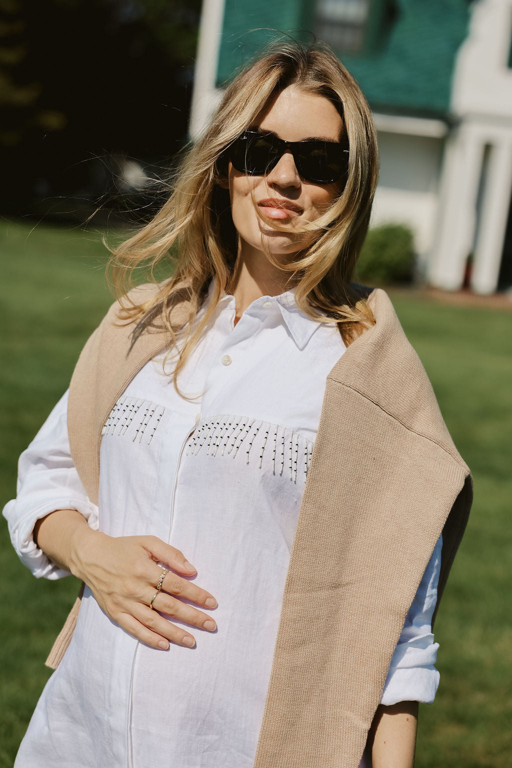 Close-up of hand-beaded black and white fringe detail on white linen Ulu Dress at Montauk Yacht Club, artisan beach cover-up dress MTK Puka The Label 2026