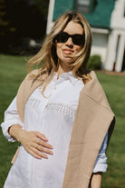 Close-up of hand-beaded black and white fringe detail on white linen Ulu Dress at Montauk Yacht Club, artisan beach cover-up dress MTK Puka The Label 2026