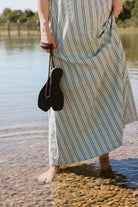 Gili Green Stripe Maxi Dress hem at the water's edge in Montauk — beach maxi dress, stripe dress Nantucket summer look, coastal resort wear