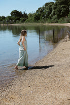 Gili Green Stripe Maxi Dress walking along Montauk shoreline — MTK beach dress outfit, relaxed stripe maxi dress for Nantucket and East End summer days