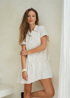 Short sleeve button-up dress in beige gingham that is neutral. Preppy, easy to wear thrown on dress that is flattering