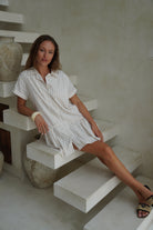 Beige check cotton mini dress European travel outfit idea summer 2026, old money aesthetic button-up dress for Mediterranean vacation and city sightseeing