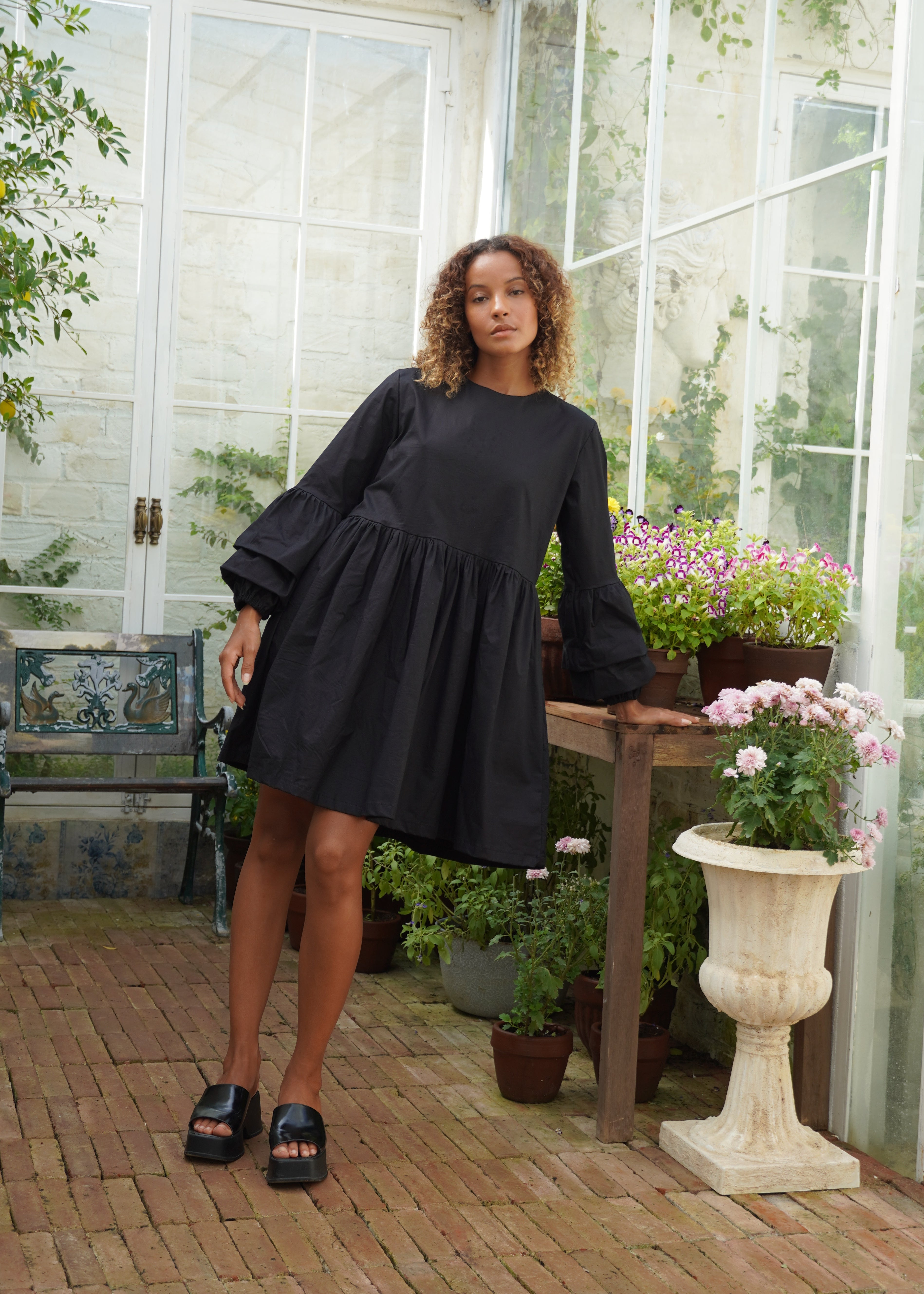 Black flattering cotton mini dress summer evening outfit 2026, ruffle sleeve Nori Dress for date night and warm weather occasion Puka The Label