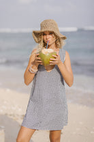 Black gingham mini Gili dress — fun bachelorette trip and girls weekend summer outfit in reversible cotton by Puka The Label