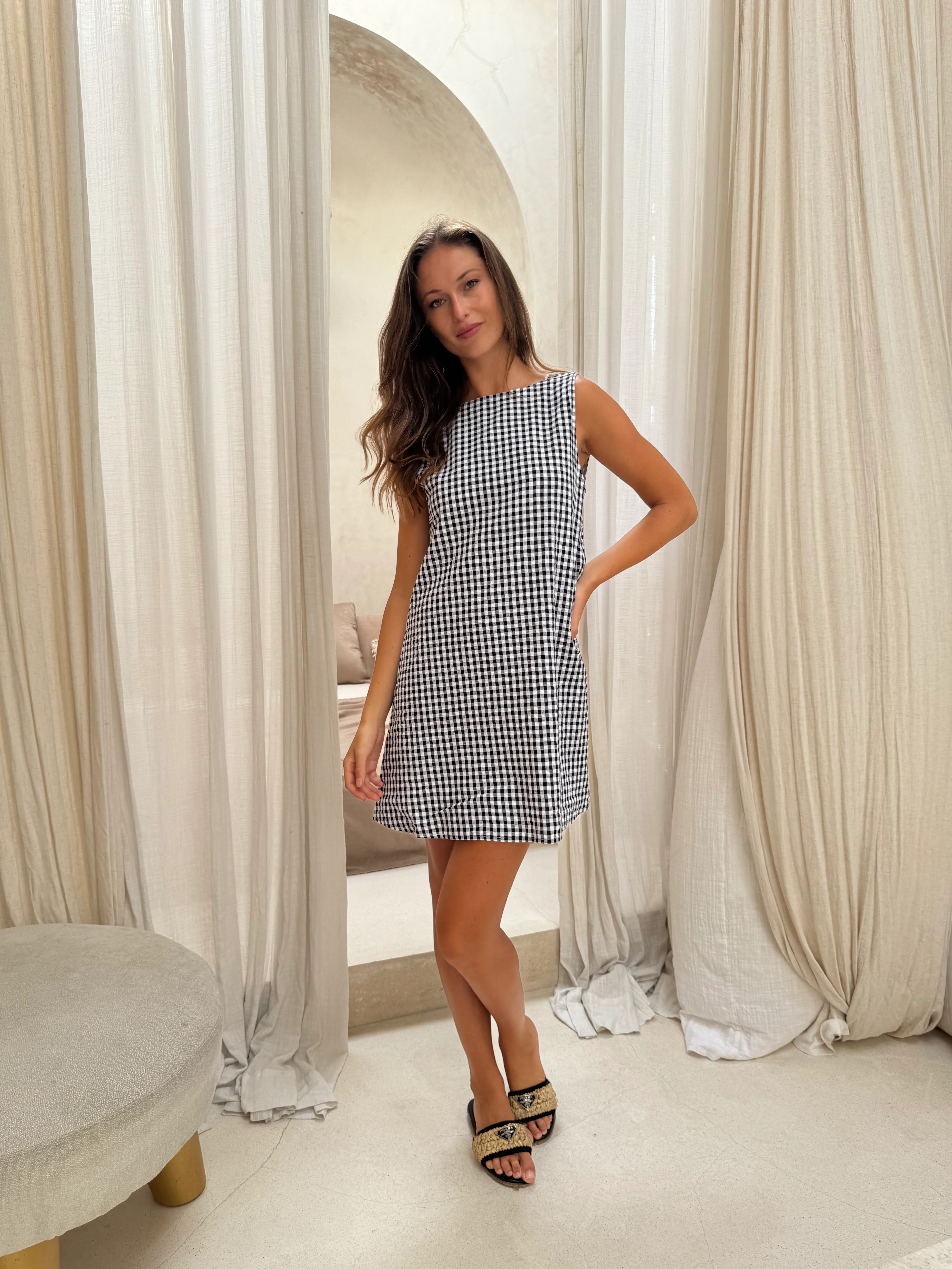 Black gingham mini Gili dress — close-up of the reversible V-neck and high neck neckline detail by Puka The Label