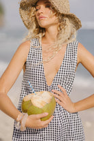 Black gingham reversible cotton mini Gili dress — detail of the signature gingham check pattern by Puka The Label