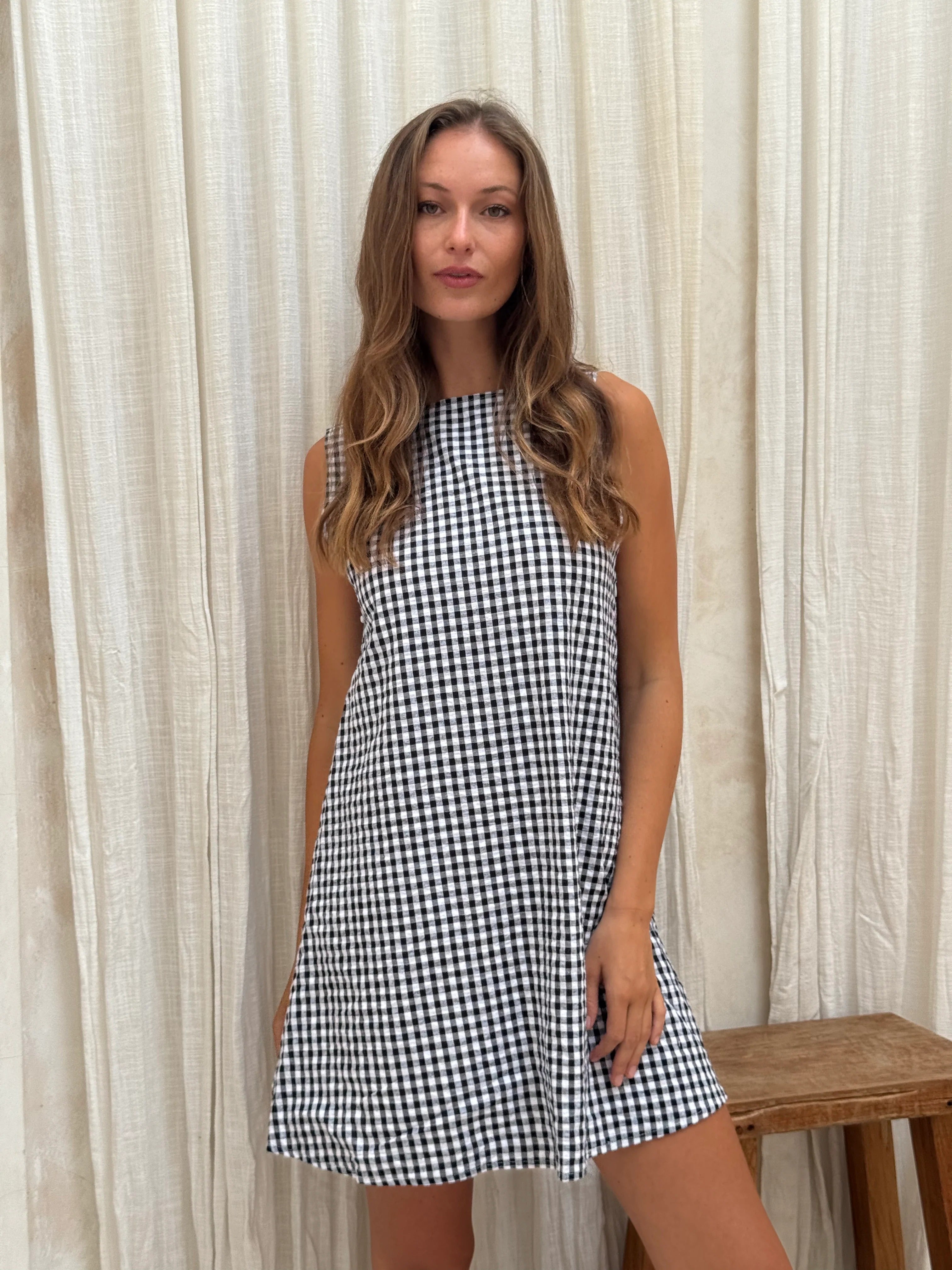 Black gingham mini Gili dress — side profile of the reversible cotton mini silhouette by Puka The Label