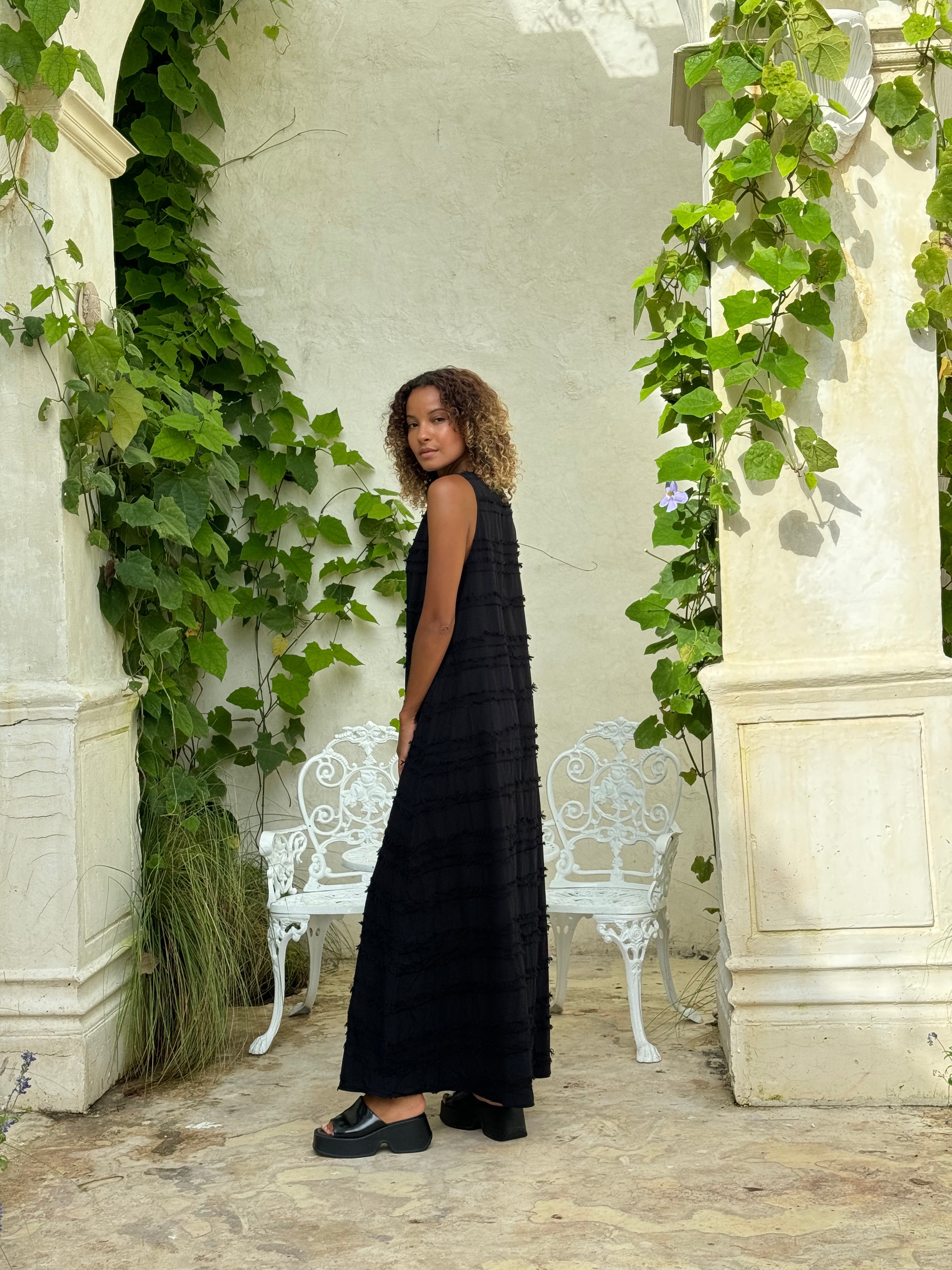 Textured black maxi dress movement — easy throw-on polished travel dress