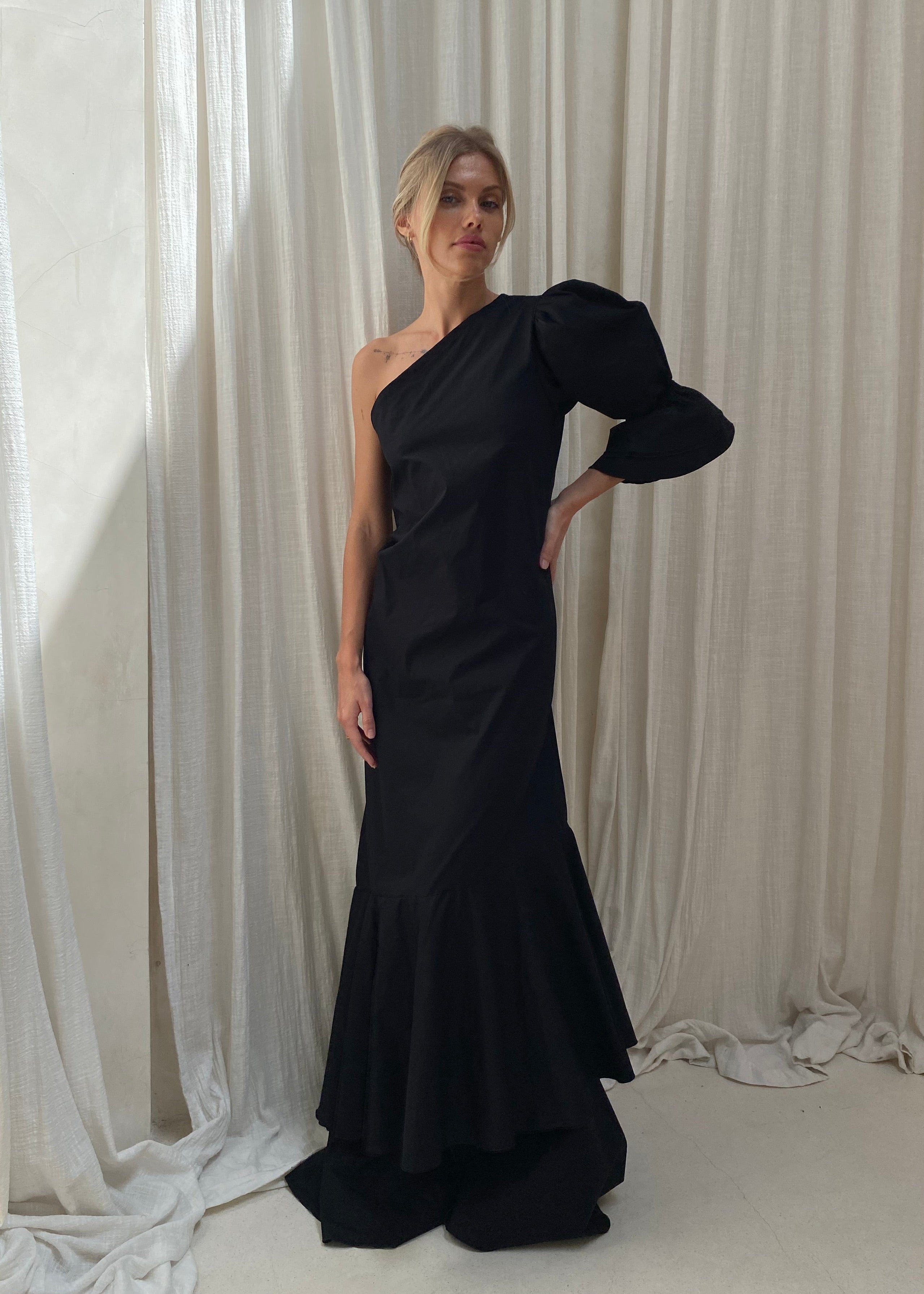 Black ruffle maxi dress styled with sandals for summer evening look, effortless coastal chic outfit women 2026