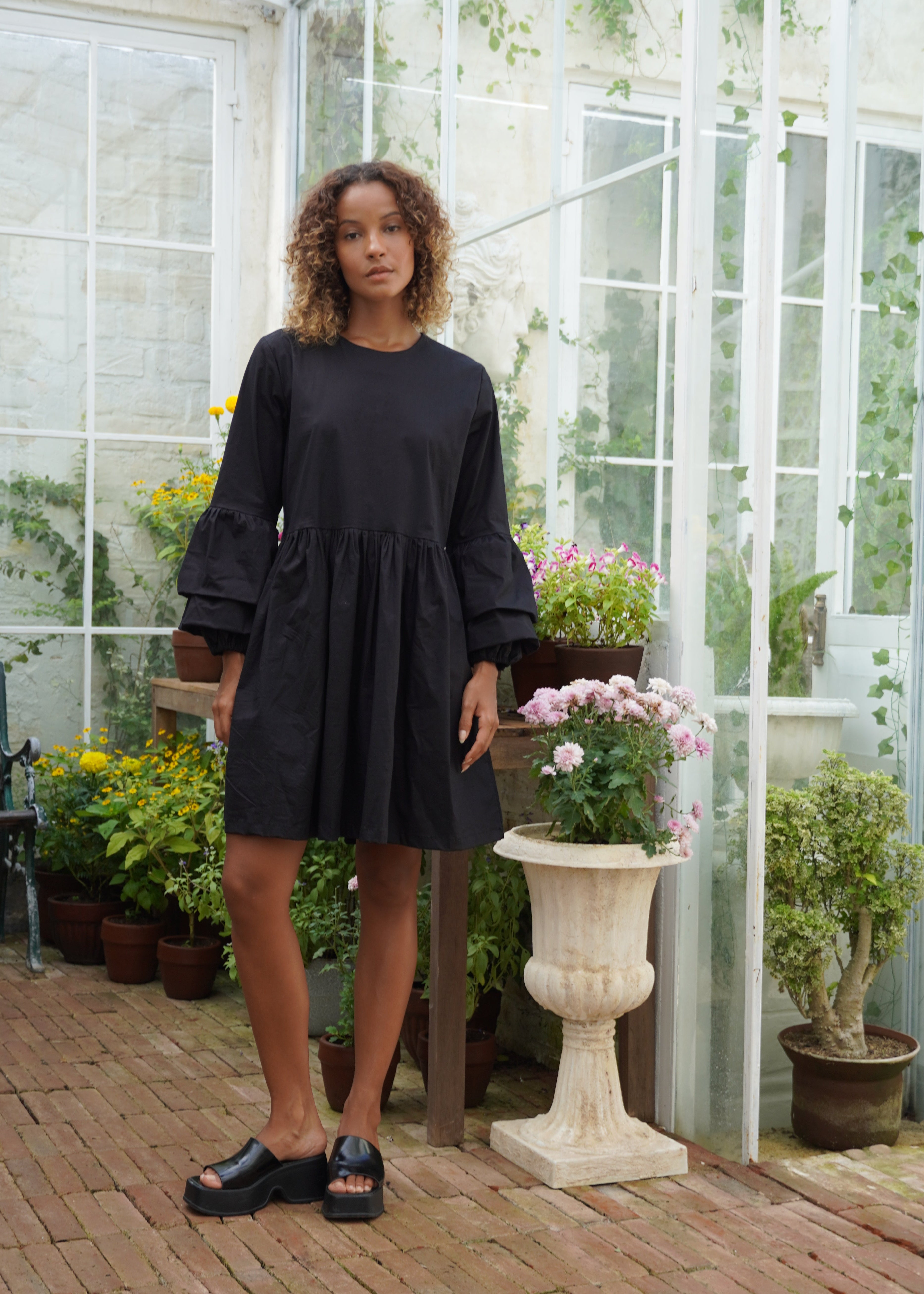 Black ruffle sleeve cotton mini dress bachelorette weekend outfit summer 2026, fun elevated mini dress for girls trip and coastal celebration