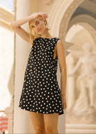 Black and white polka dot mini dress European summer vacation outfit 2026, chic short cotton dress for city sightseeing, cafe hopping, and travel
