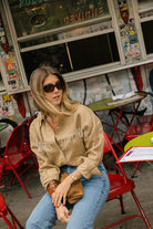 Puka The Label camel Ulu fringe top — a Sun Valley-inspired western blouse in camel linen with white fringe for fall travel
